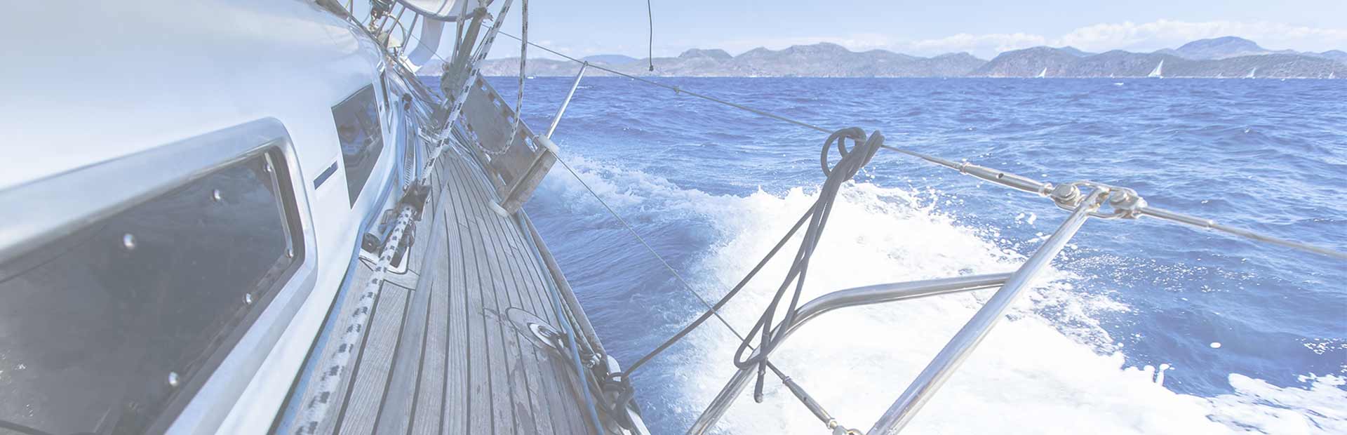 View from side deck of boat, looking aft towards the mainland from the ocean.