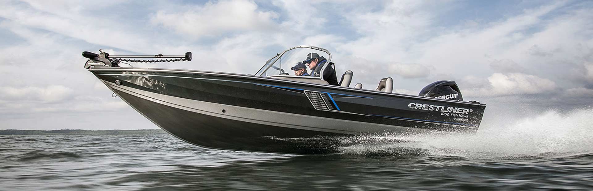 Crestliner 1950 FIsh Hawk speeding across the top of the water with two people.