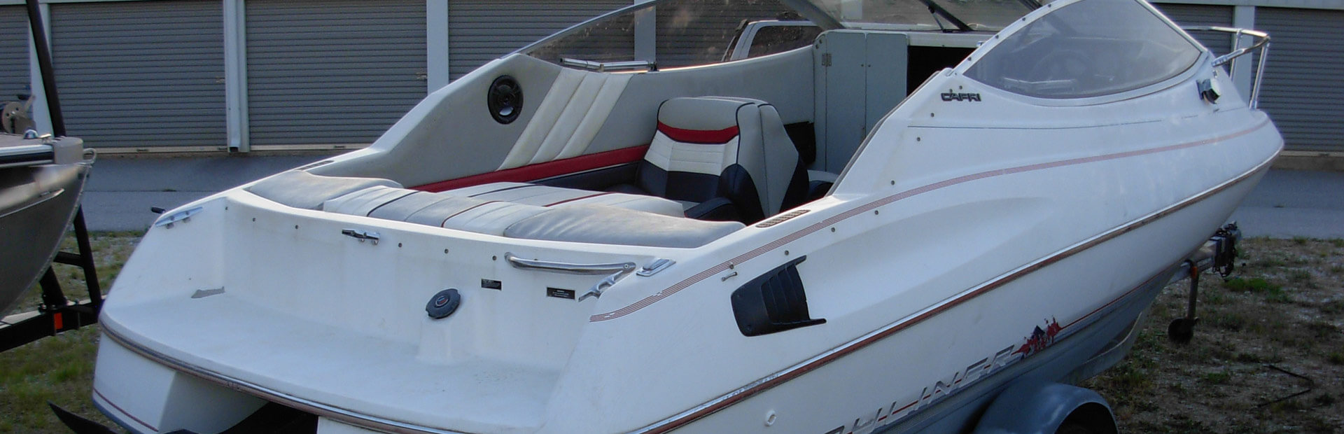 Cuddy Cabin Boat on trailer at storage yard.